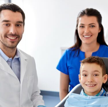 Smiling boy with the dentist in Streetsville.