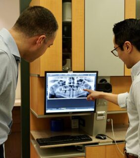 dentists examing x-ray of teeth