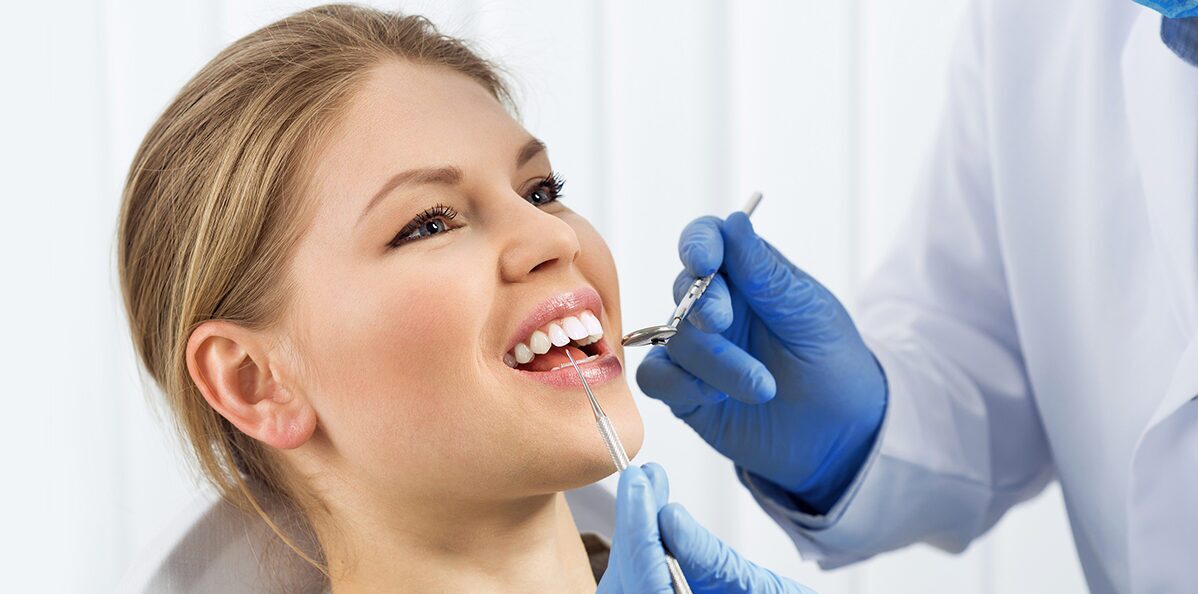 Girl smiling while dentist doing treatment