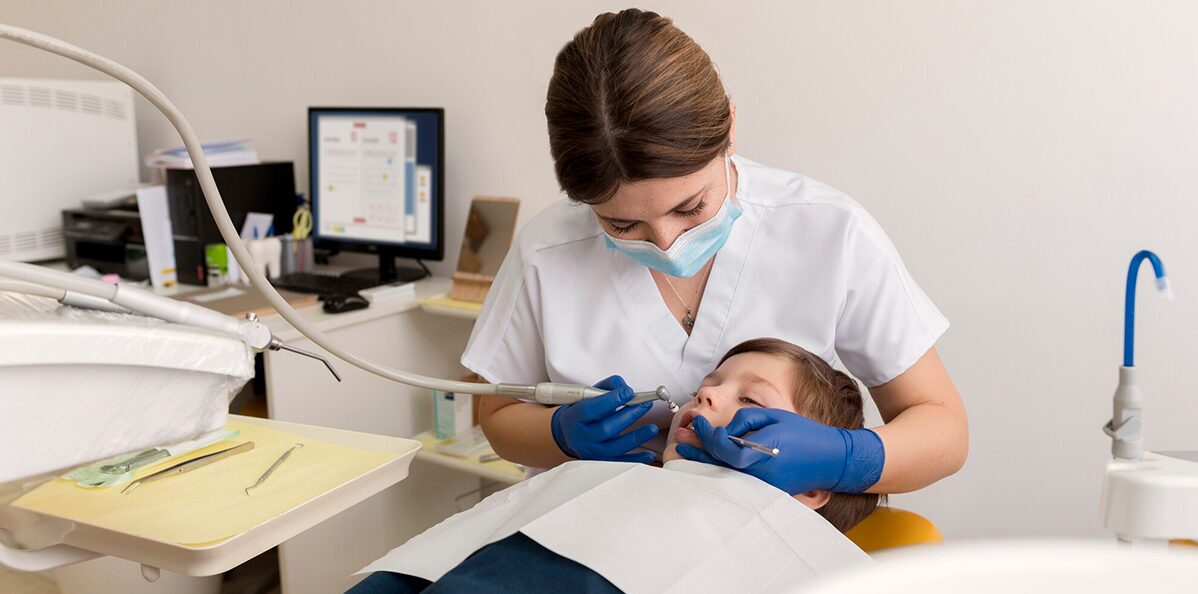 dentist is treating kids mouth