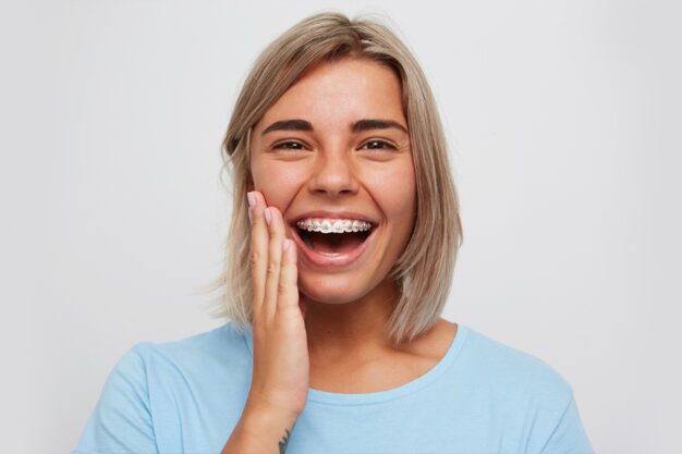 Girl smiling happliy with braces on teeth
