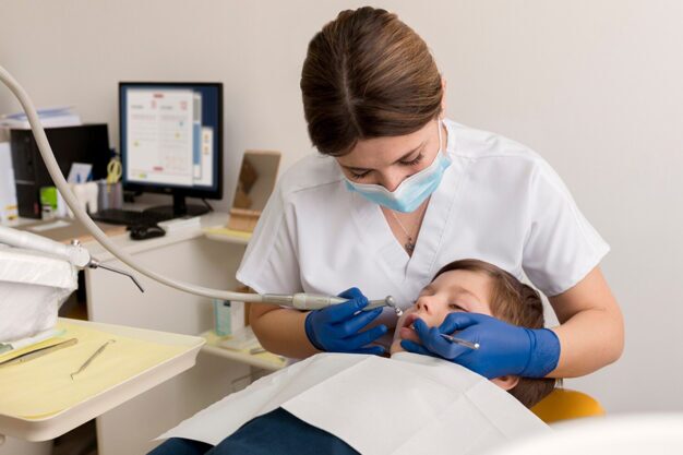 dentist is treating kids mouth